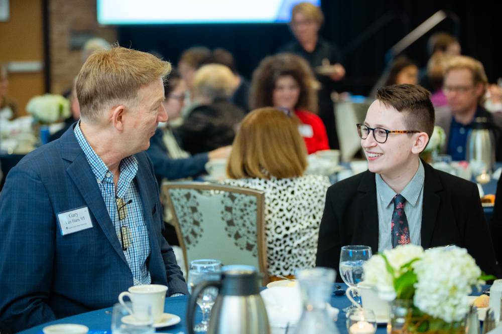 Student with a donor chatting at a table at Scholarship Dinner 2019